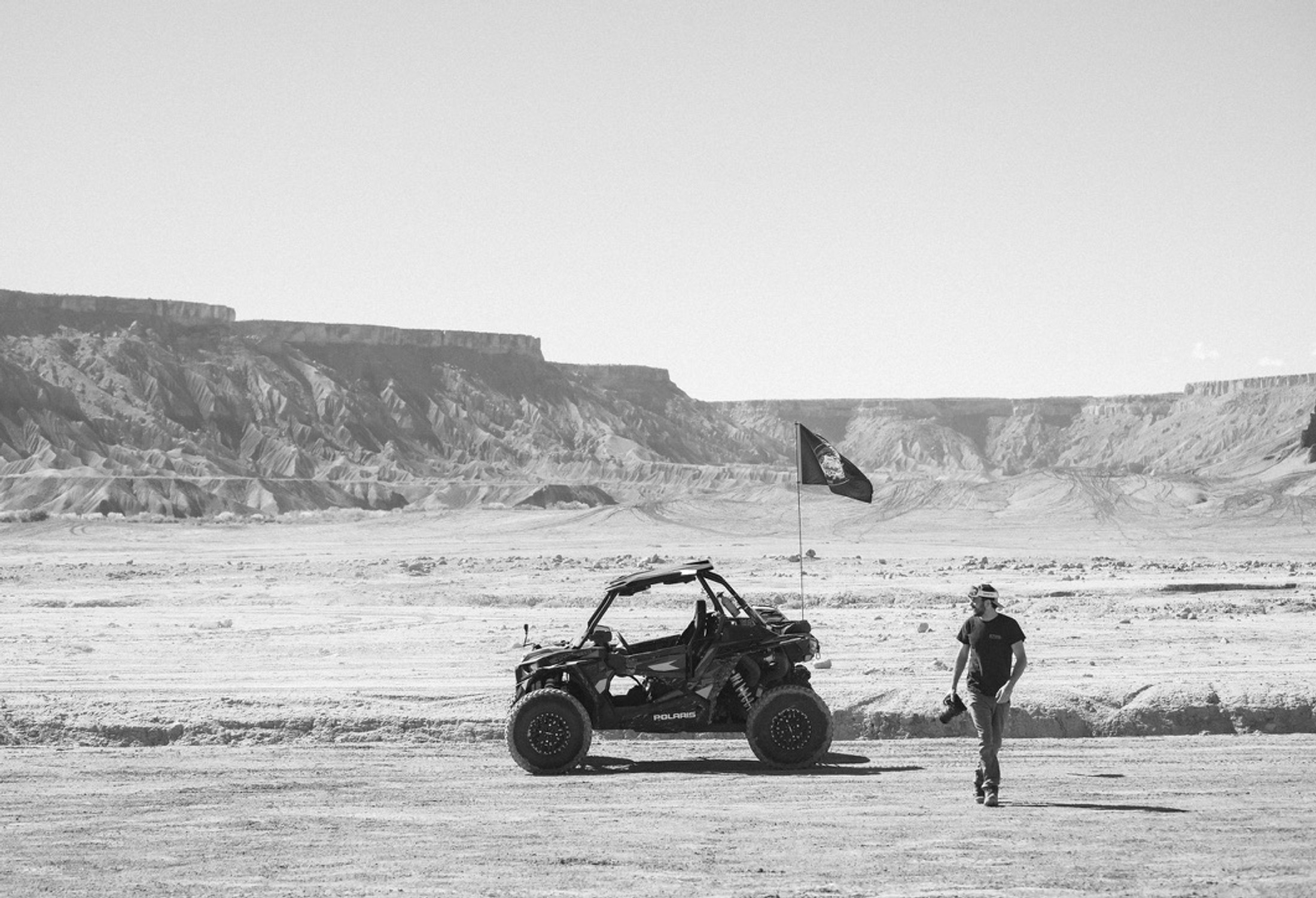 Wes Campbell walking to a Polaris RZR in the Utah desert